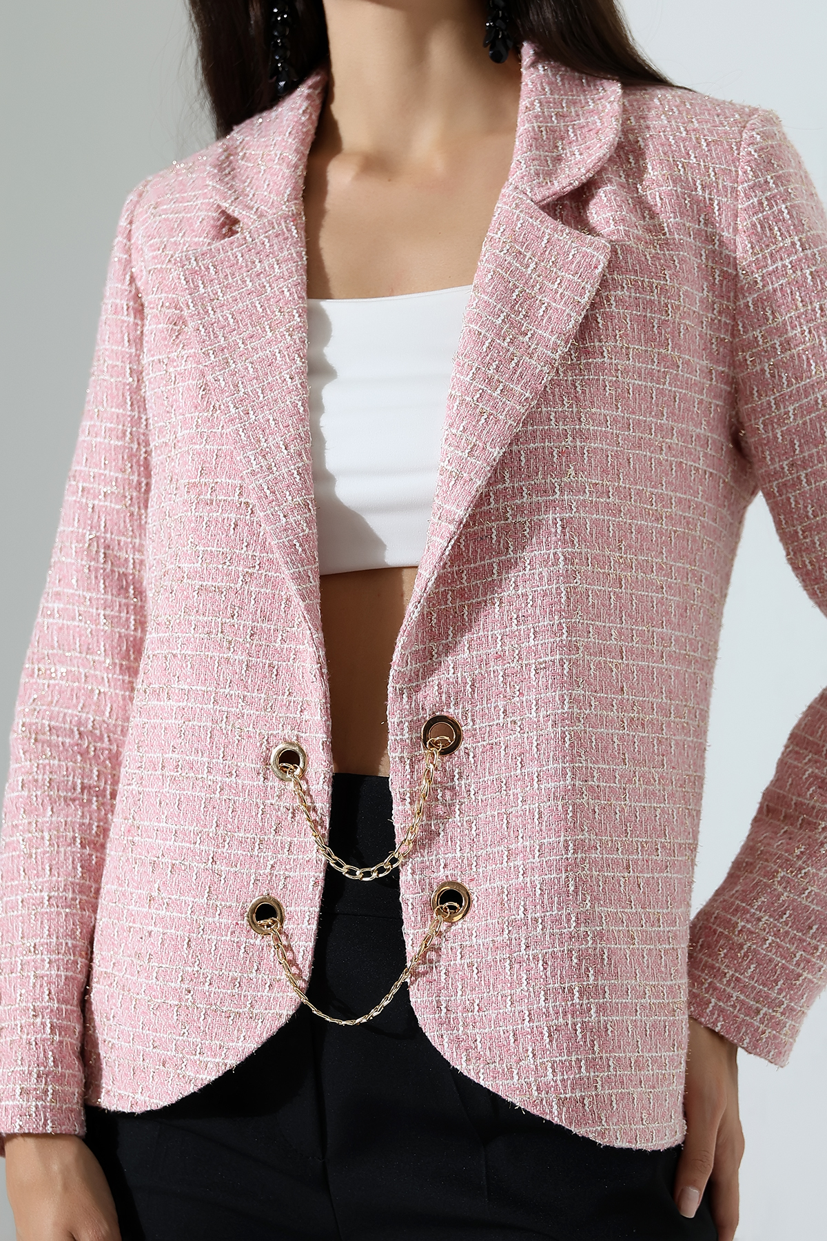 Close up of fastening on pink woven jacket